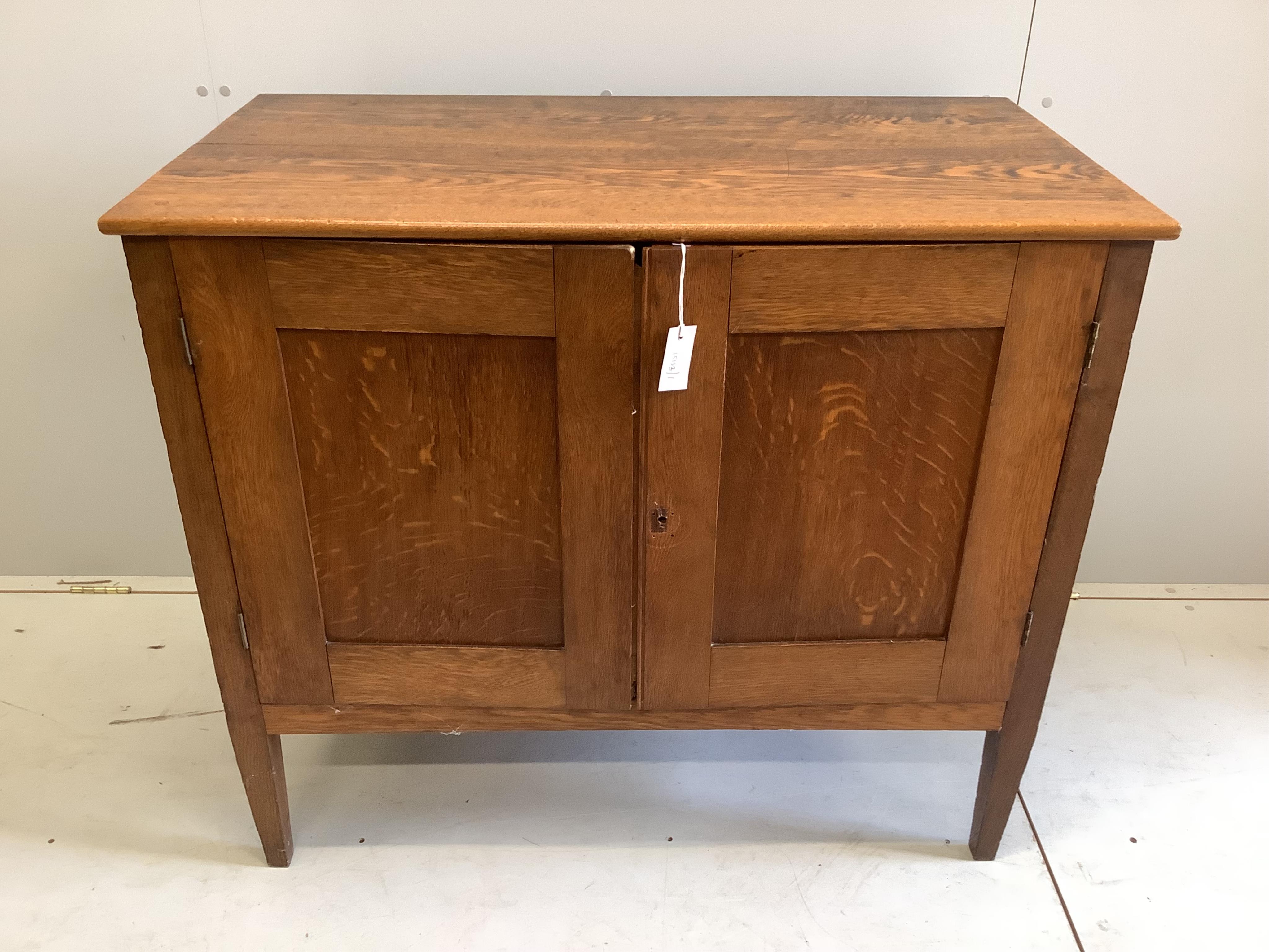 An early 20th century Continental oak press cupboard, width 106cm, depth 58cm, height 92cm. Condition - fair